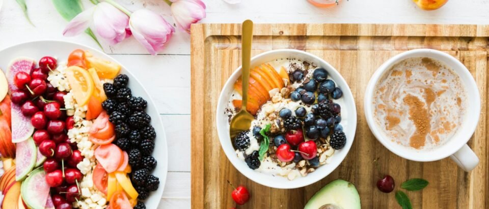 black and red cherries on white bowl