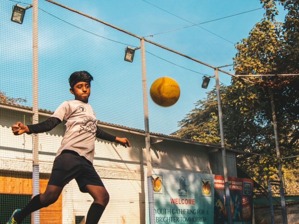 man in gray shirt playing basketball during daytime