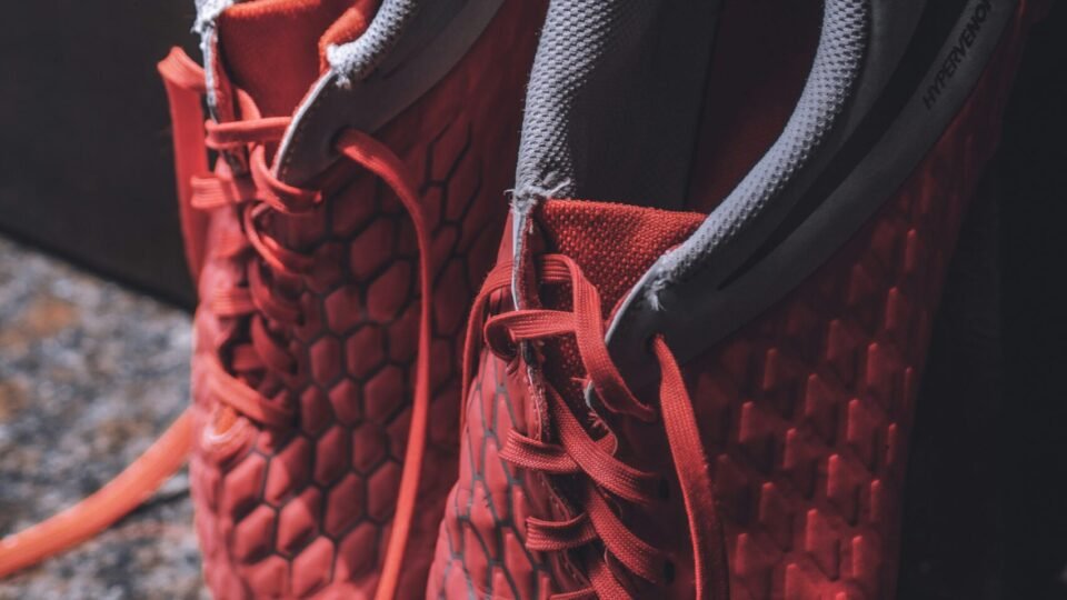 pair of grey and red shoes close-up photography