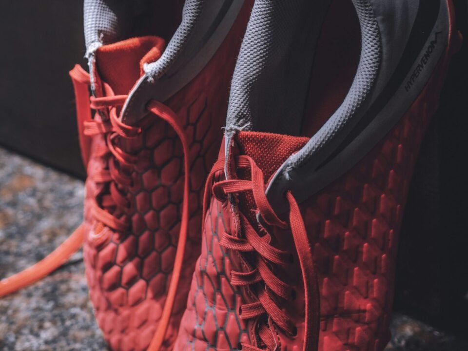 pair of grey and red shoes close-up photography